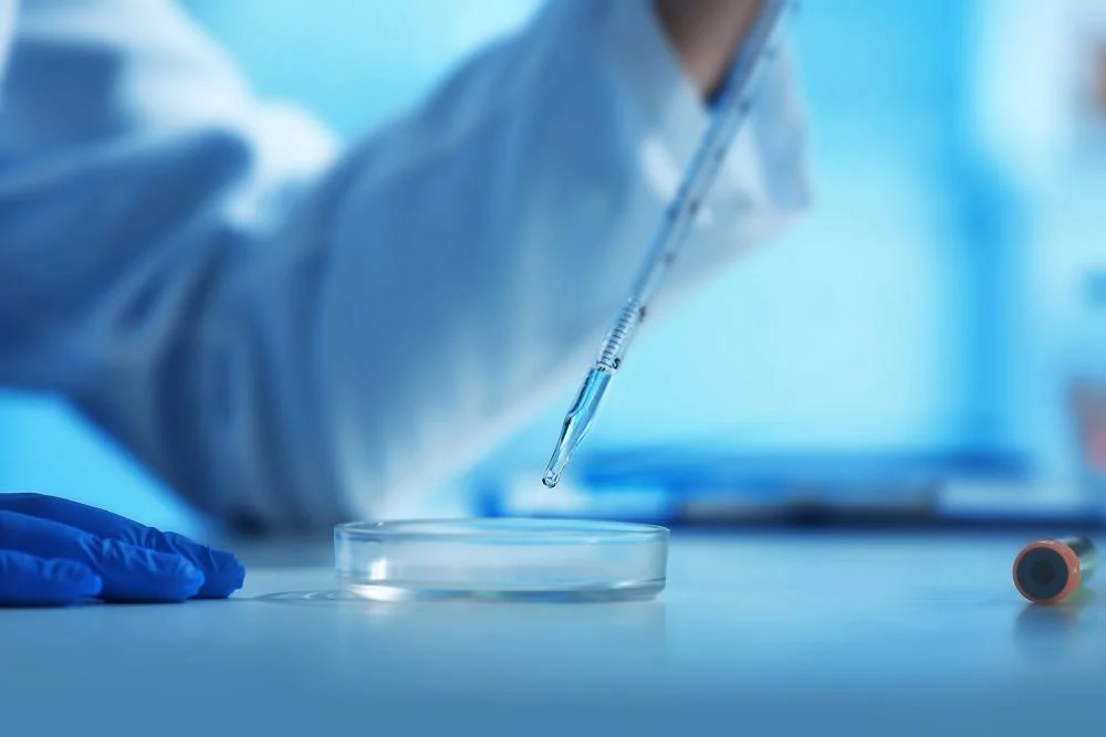 Laboratory technician using a pipette to transfer liquid into a petri dish, emphasizing research applications of Semax peptide in cognitive and neuroprotective studies.